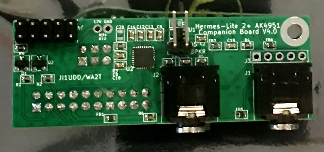 The AK4951 companion board, a small green PCB with two audio jacks
